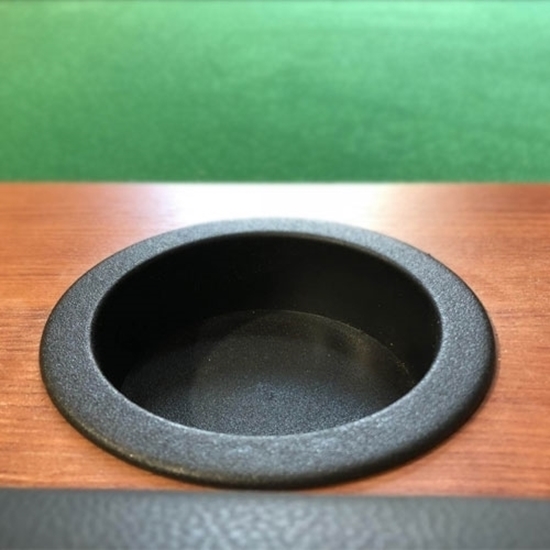 Black plastic cup holder installed in table